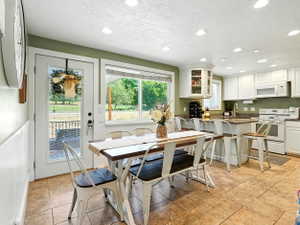Dining area with recessed lighting, a textured ceiling, and light tile patterned floors