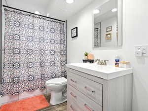 Bathroom with vanity, curtained shower, recessed lighting, and light wood finished floors