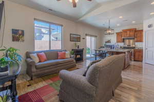 Living room with vaulted ceiling, ceiling fan, and recessed lighting