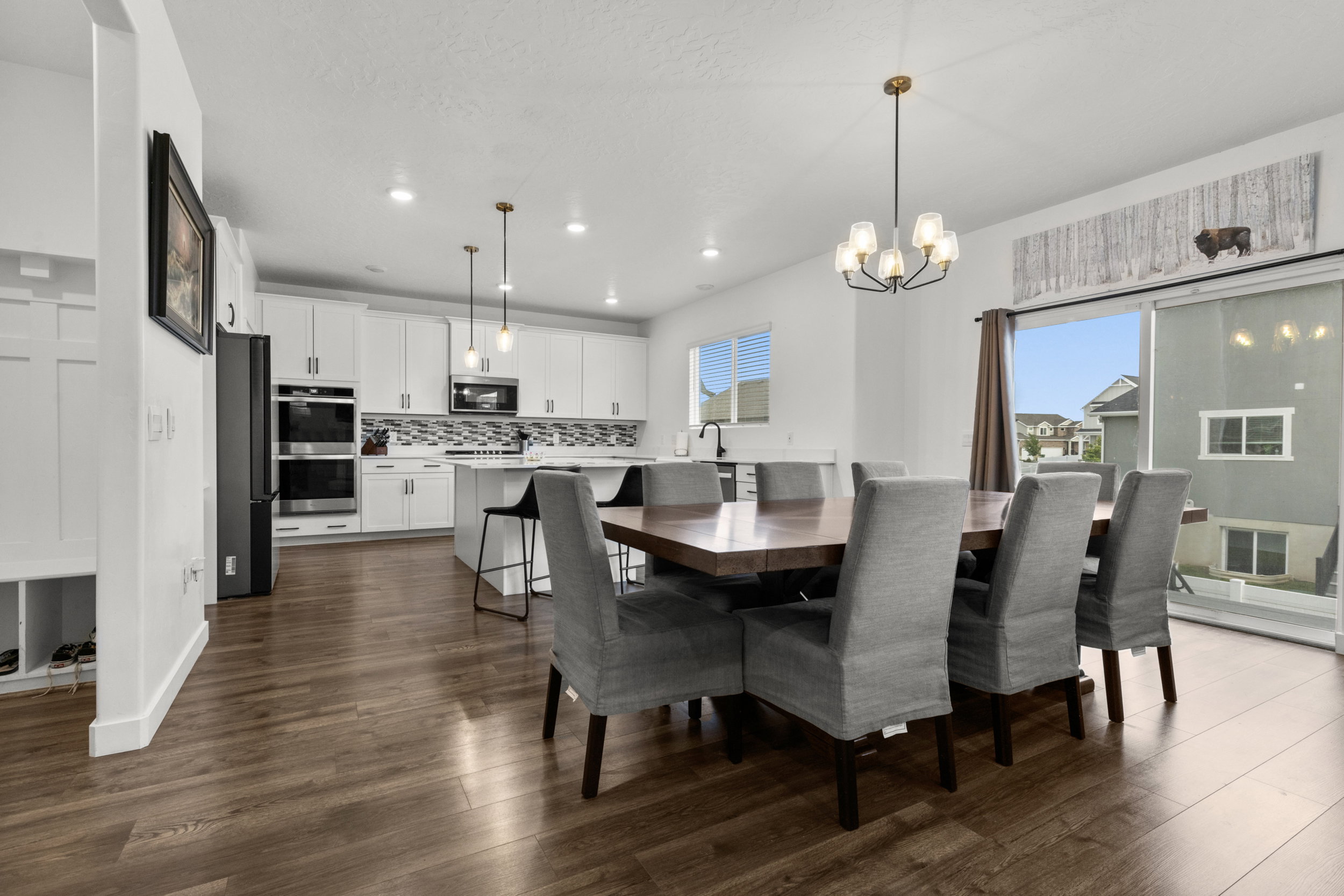 Dining area featuring dark wood finished floors and hanging lights