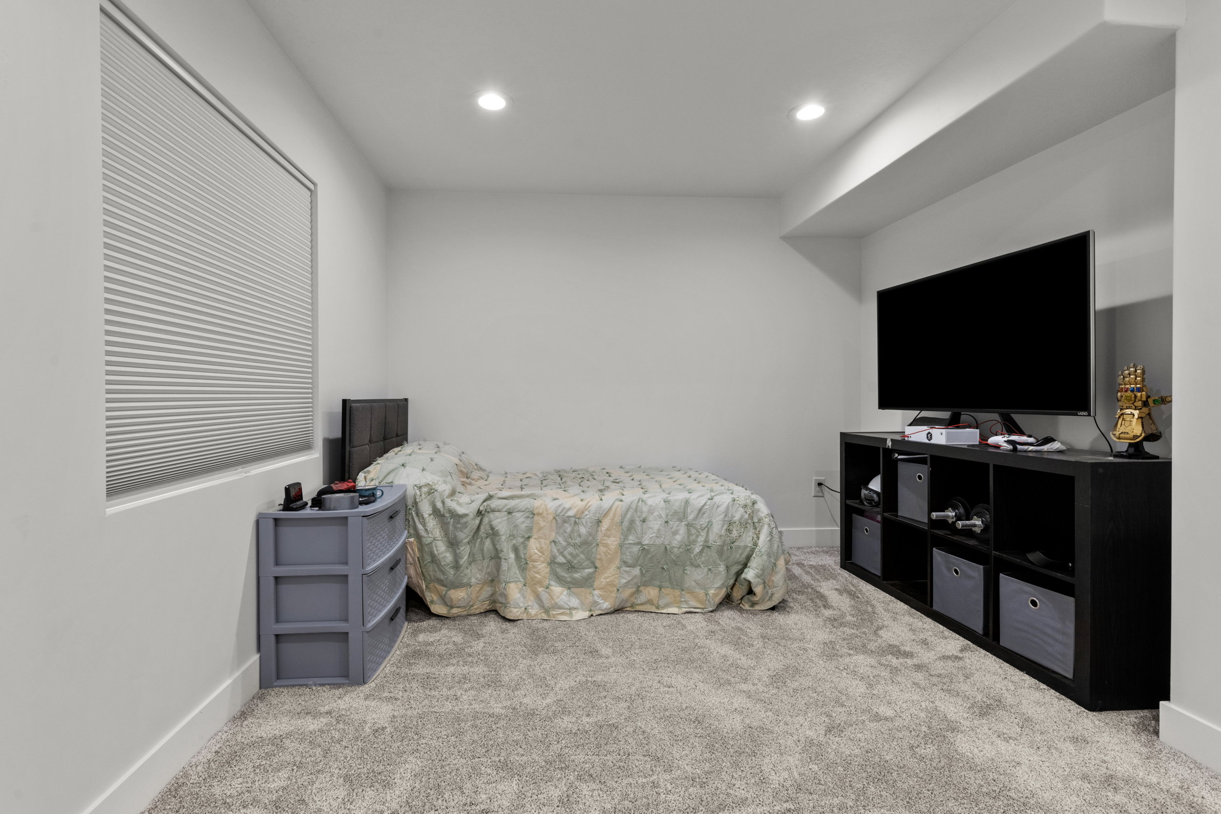 Bedroom with light colored carpet and recessed lighting