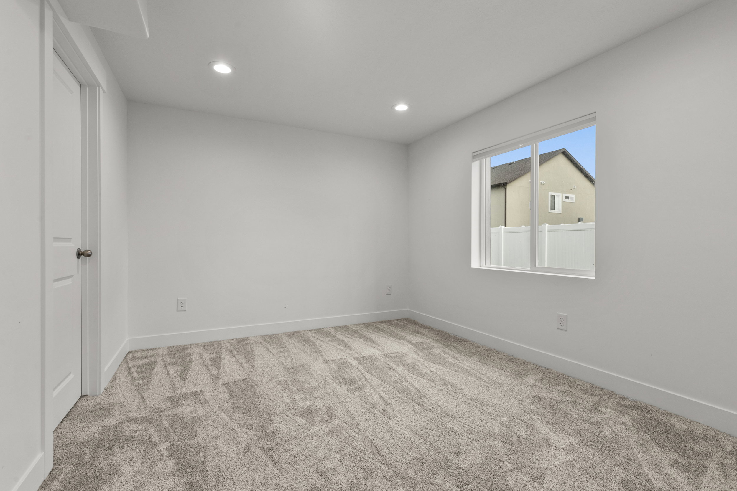 Unfurnished bedroom featuring light carpet and recessed lighting