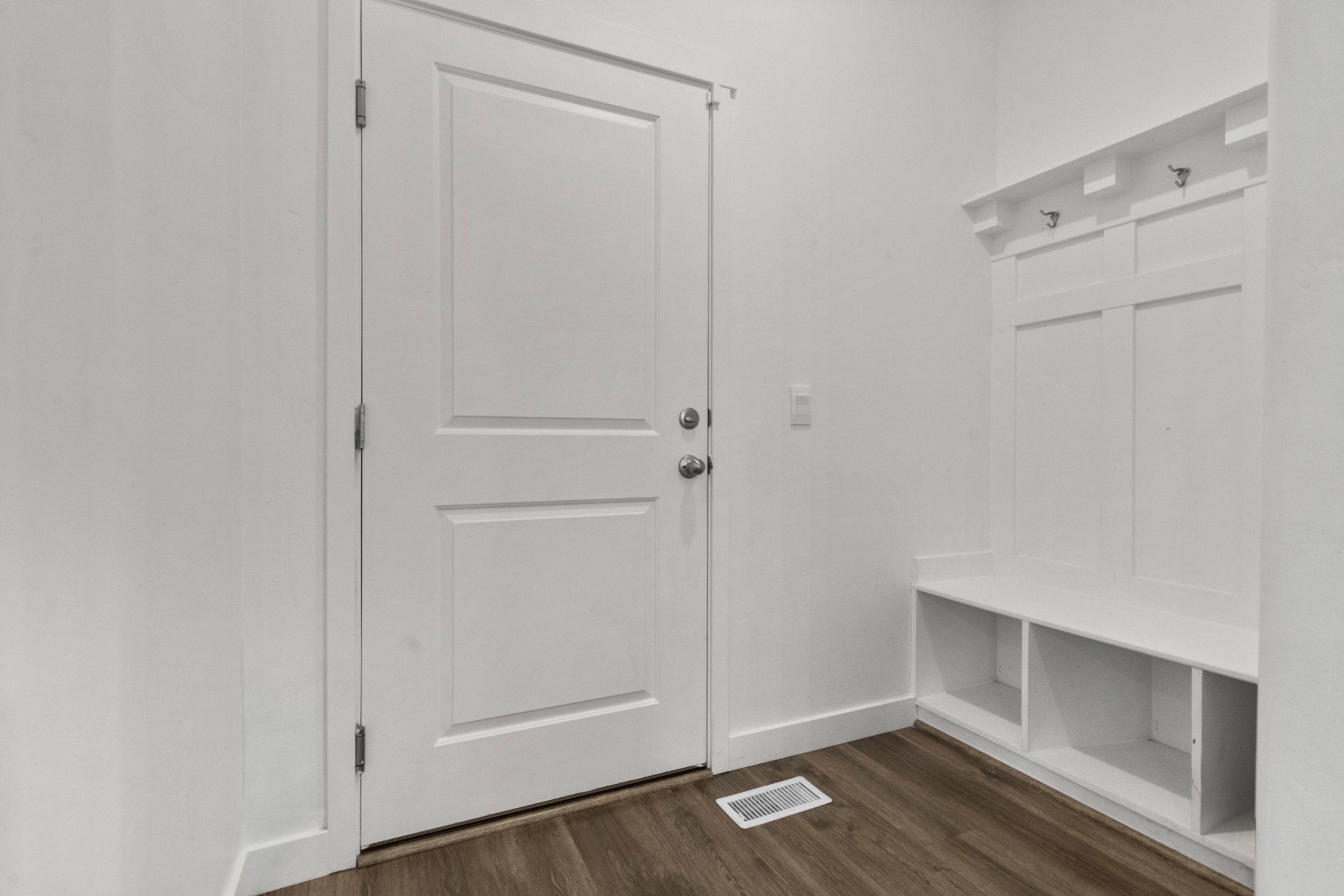 Mudroom with dark wood-style floors and baseboards
