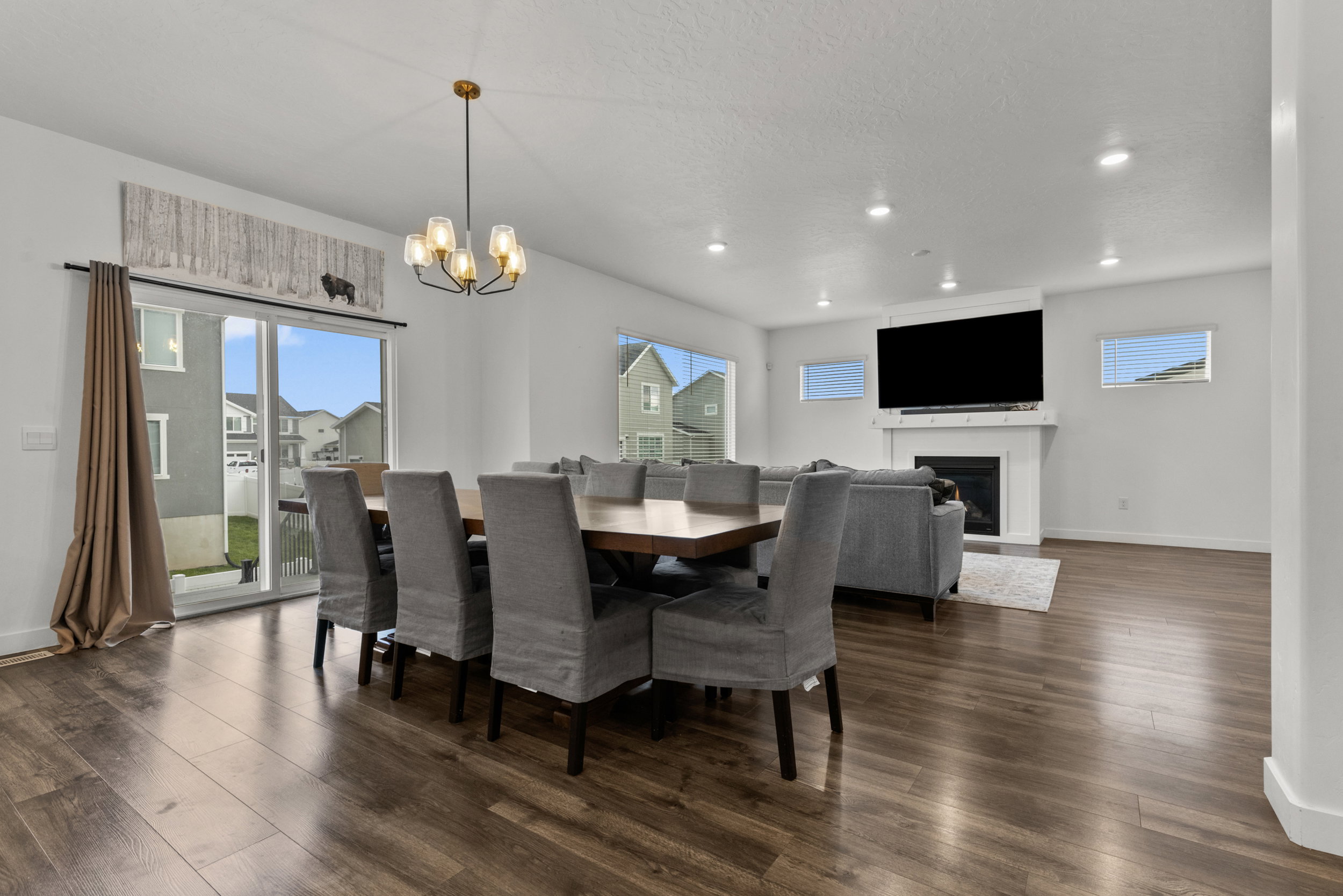 Dining area featuring dark wood-style flooring, suspended lighting, plenty of natural light, and a textured ceiling