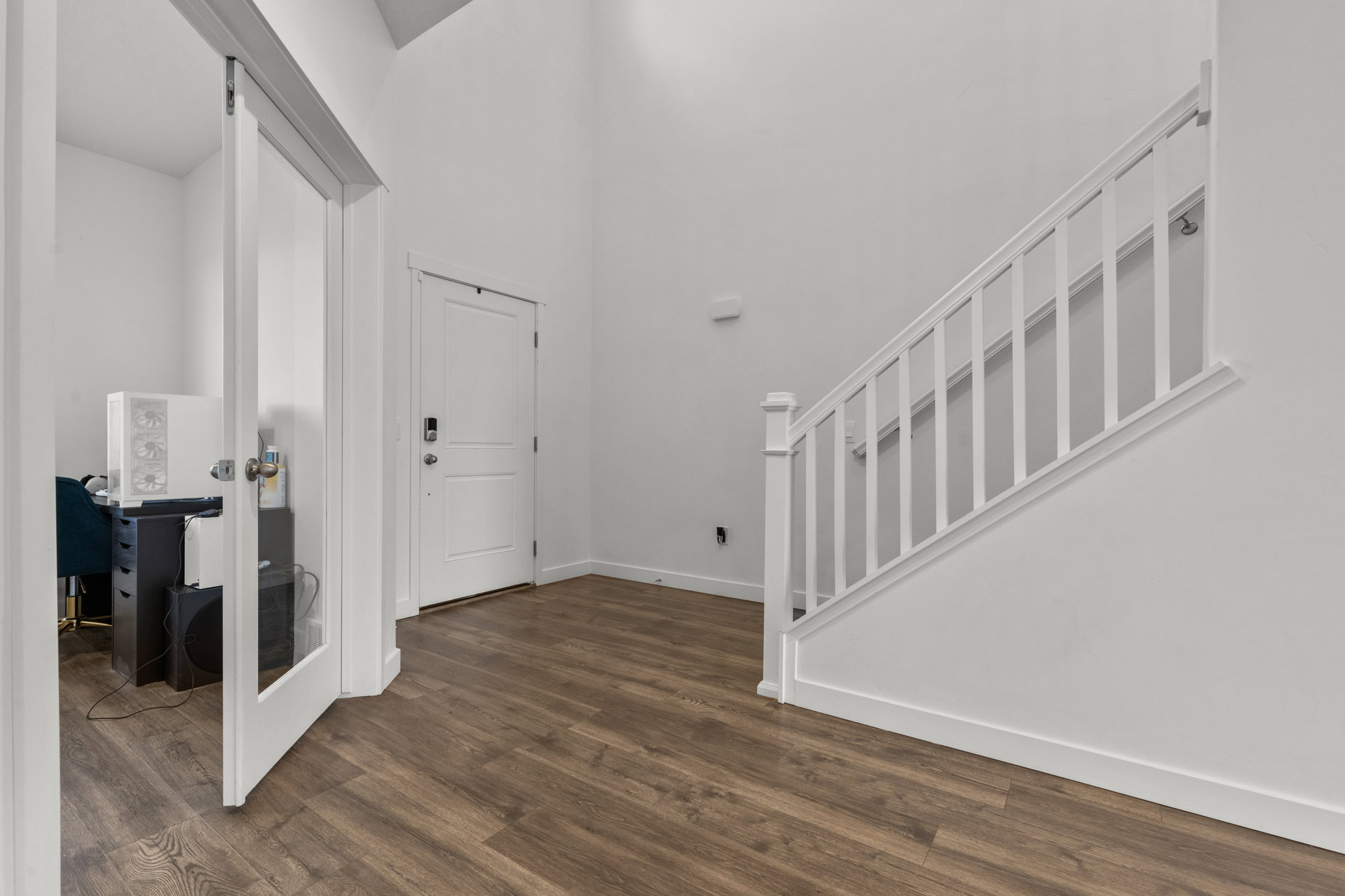 Entrance foyer featuring a high ceiling and dark wood-type flooring