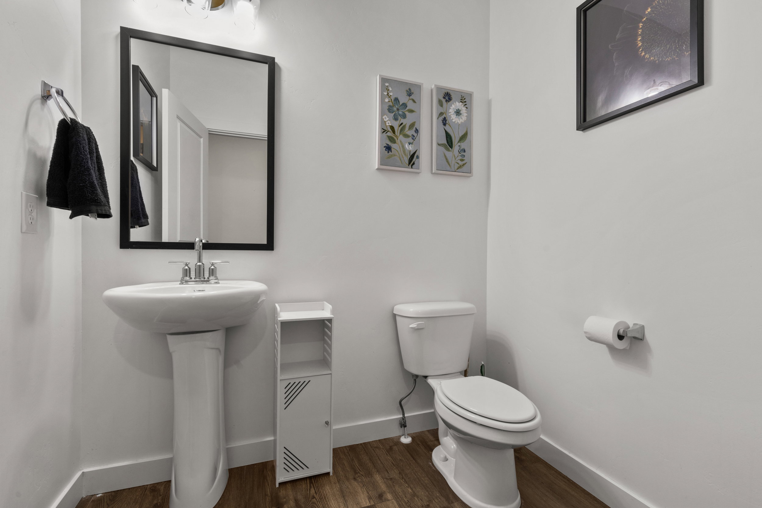 Half bath with toilet and dark wood-style floors