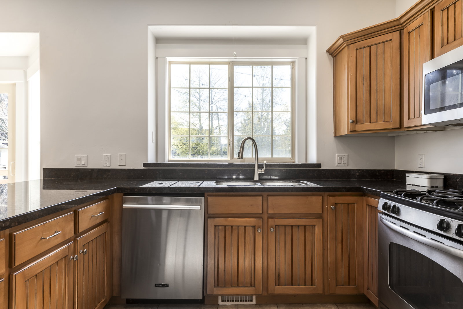 Kitchen with wood finish cabinetry and stainless steel appliances