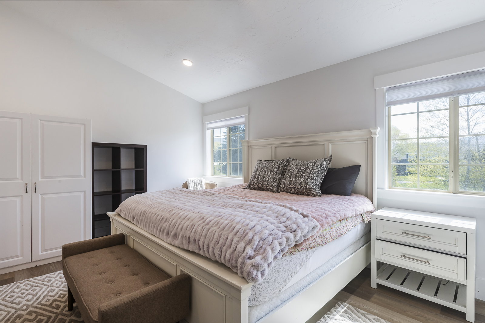 Bedroom featuring wood finished floors, lofted ceiling, and recessed lighting