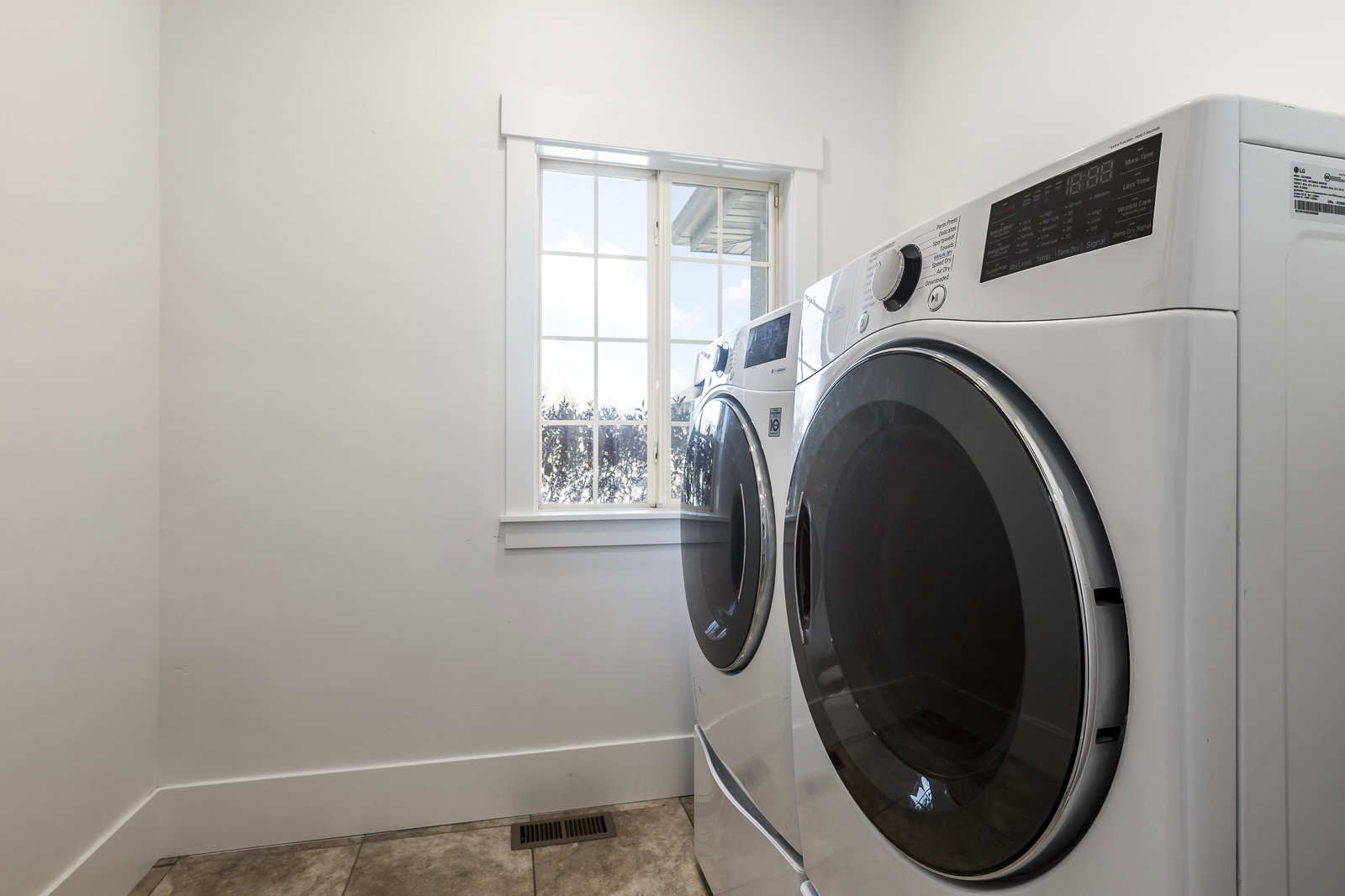 Laundry room featuring washer and dryer and light tile patterned floors