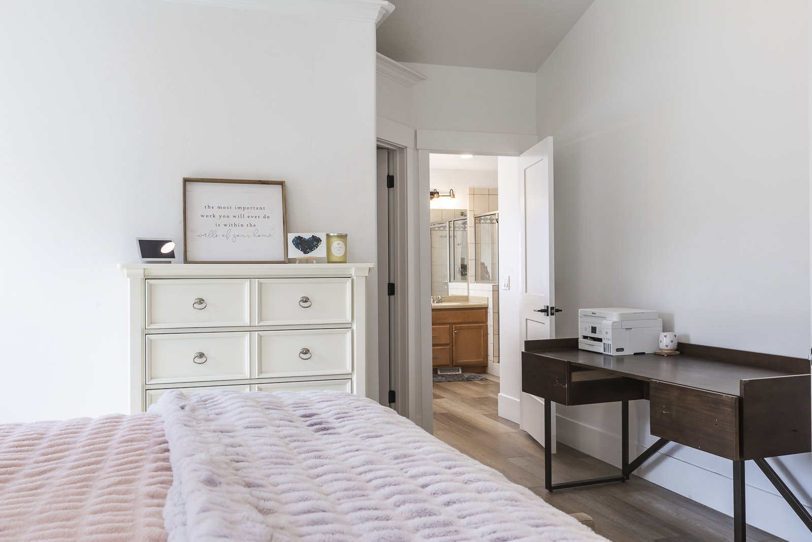 Bedroom with wood finished floors and ensuite bathroom