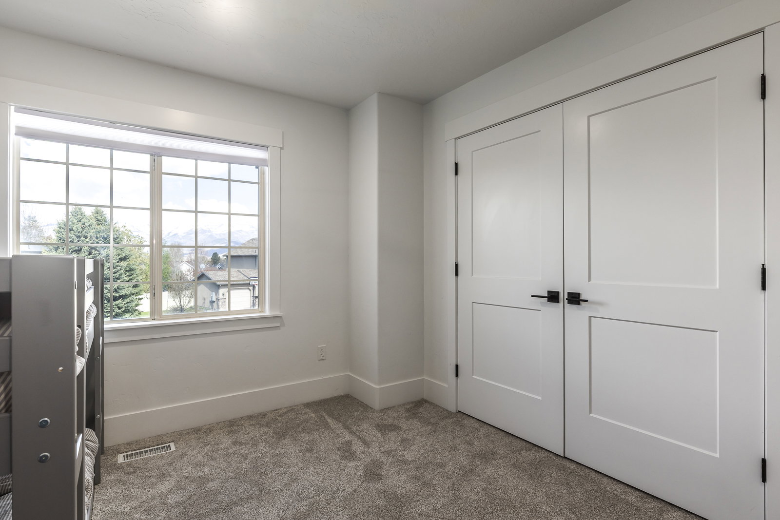Unfurnished bedroom featuring light colored carpet and a closet