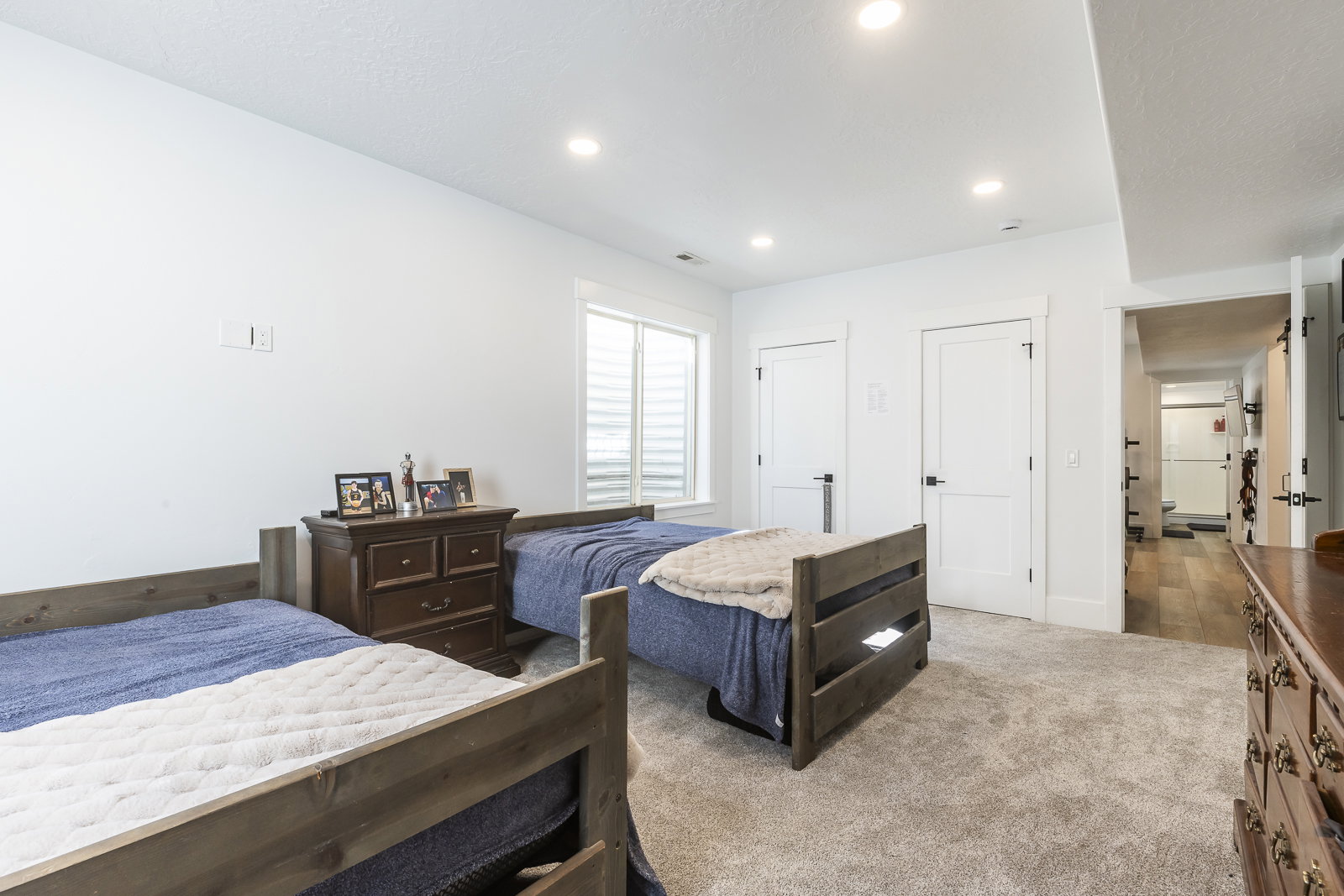 Bedroom featuring two closets, carpet flooring, and recessed lighting