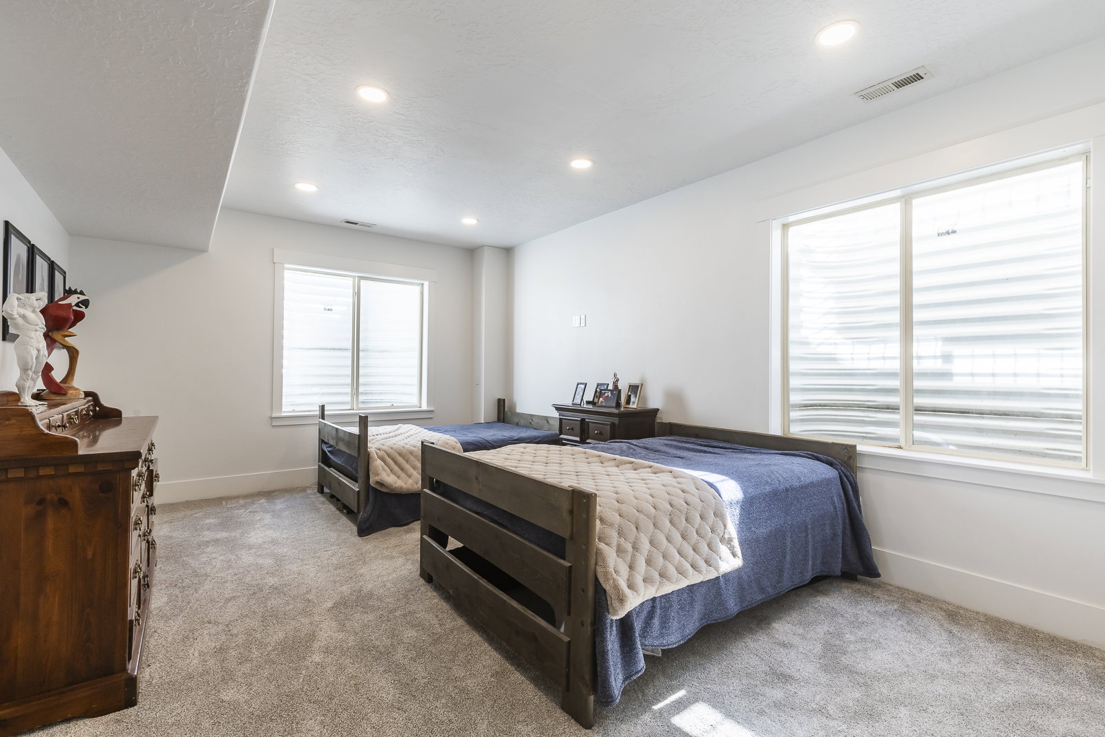 Bedroom with recessed lighting and light carpet