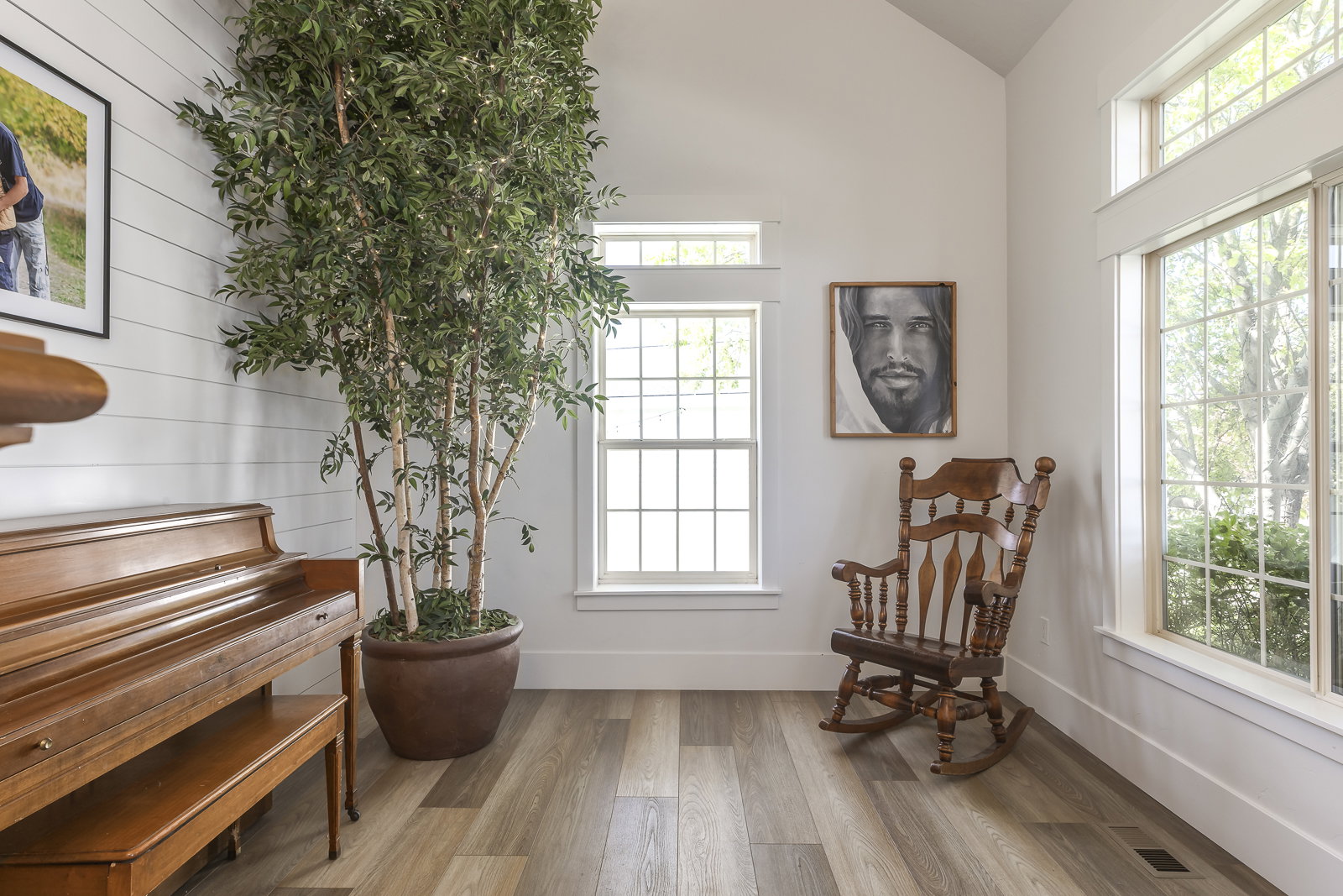 Sitting room with light wood-style floors and lofted ceiling