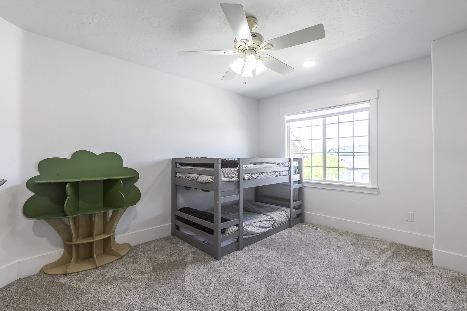Carpeted bedroom featuring baseboards and ceiling fan