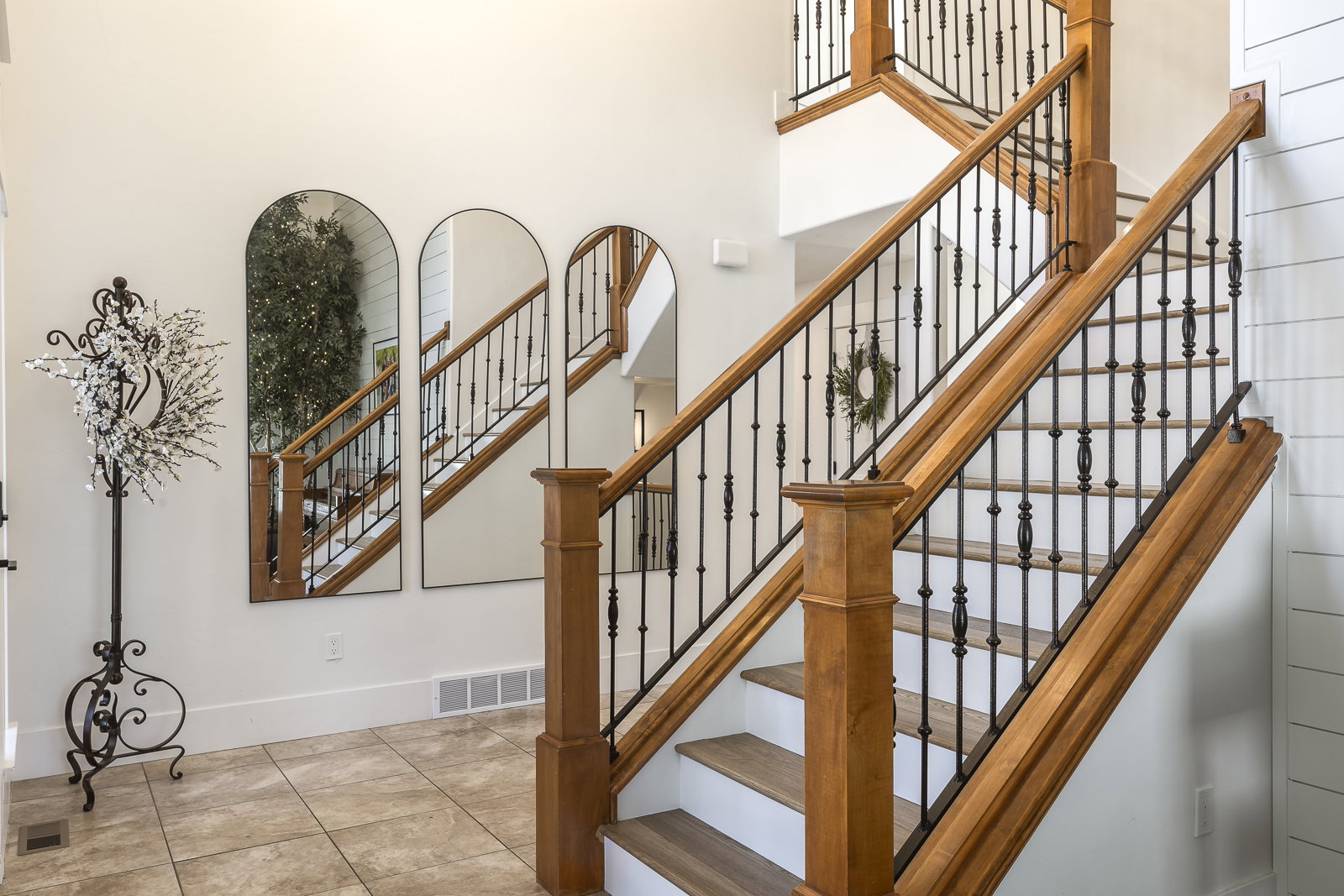 Stairway featuring tile patterned floors and a high ceiling