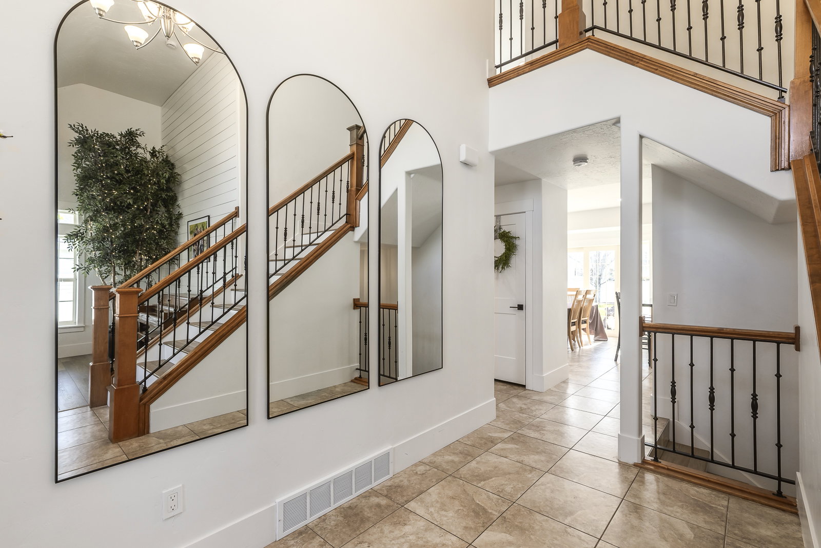 Stairs with tile patterned flooring and a high ceiling