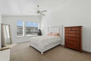 Primary Bedroom featuring vaulted ceiling, big windows, and a lot of space to spare