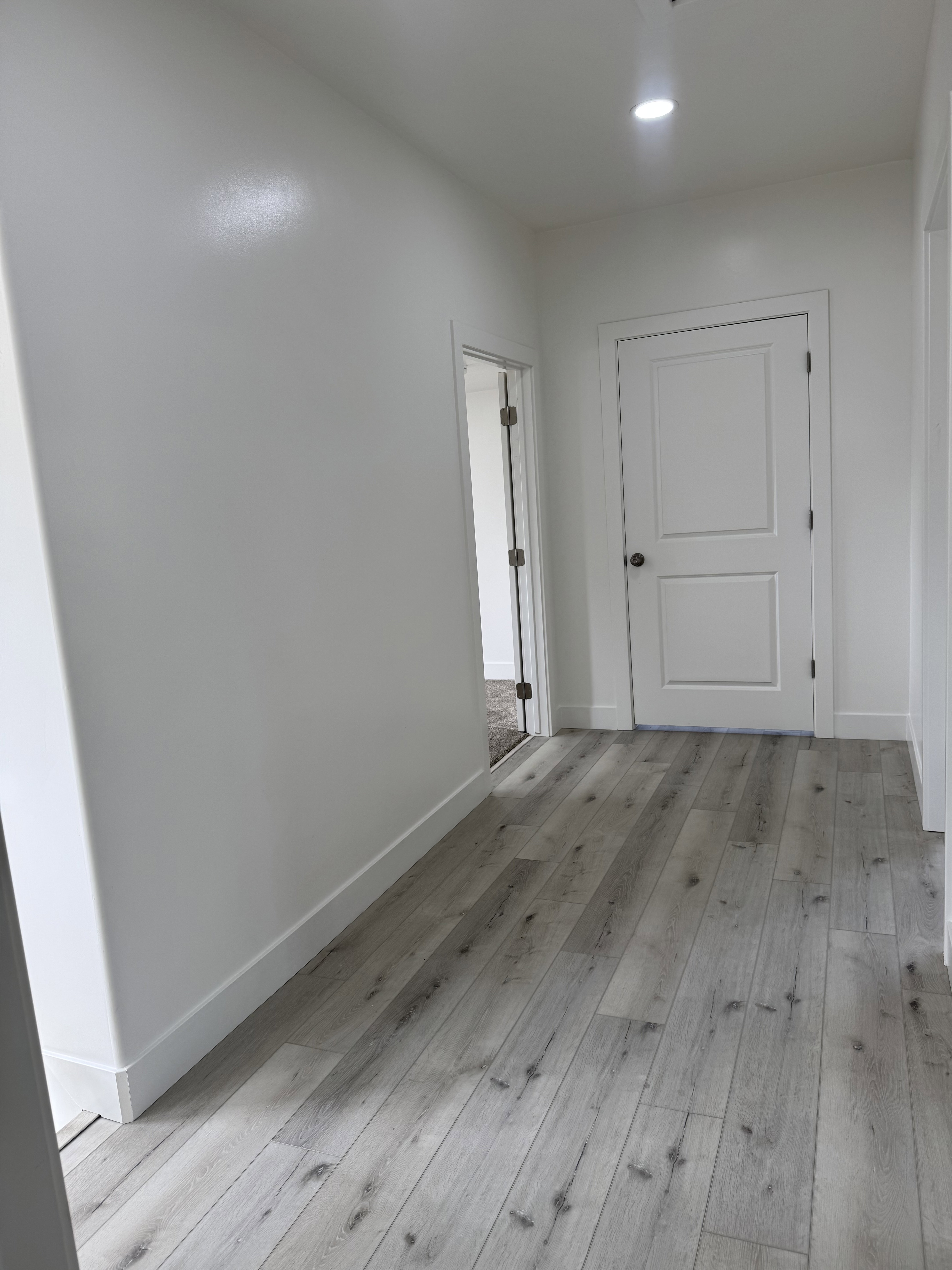 Hallway with light wood finished floors
