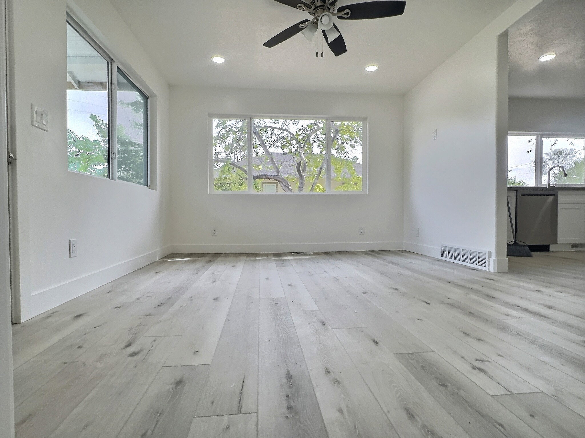 Spare room with light wood-style floors, ceiling fan, and recessed lighting