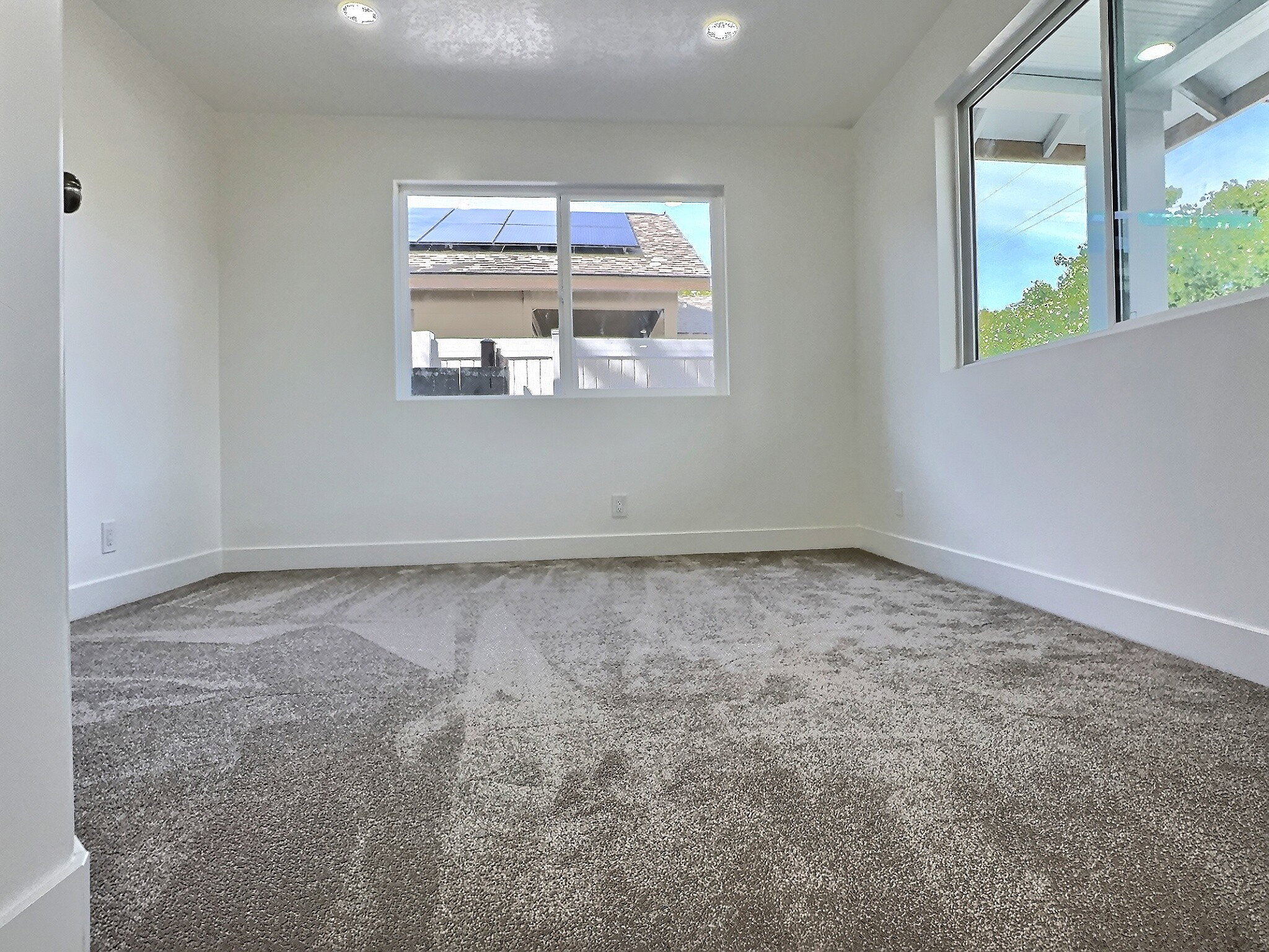 Empty room featuring carpet and baseboards
