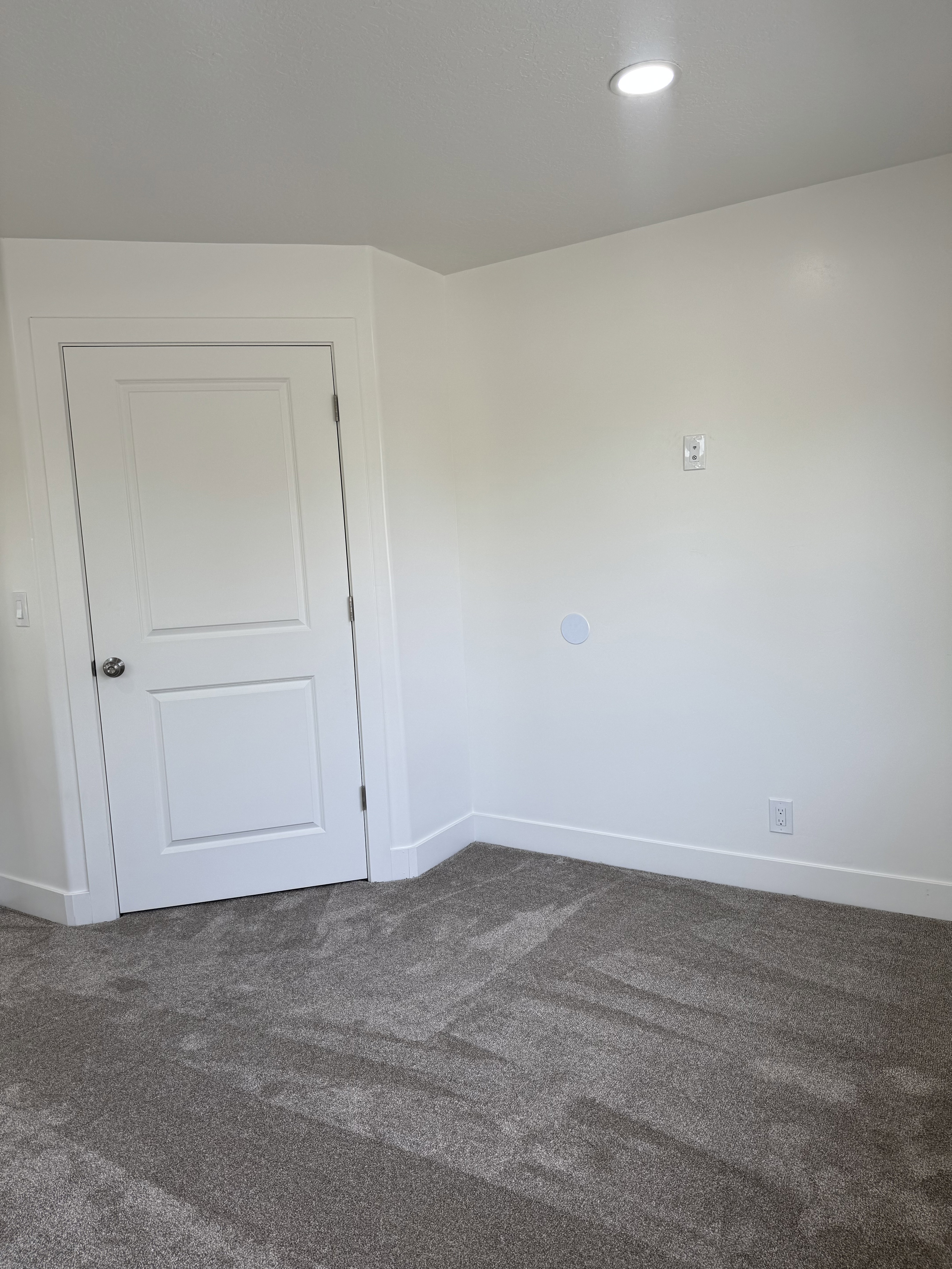 Empty room featuring baseboards and dark carpet