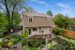 Rear view of oversized two car garage with workshop and one bedroom apartment upstairs and RV parking plumbed with RV sewer dump