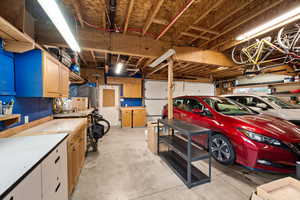 Oversized two car garage with anew garage door and garage door opener, alley access, workshop area and radiant heated garage floor
