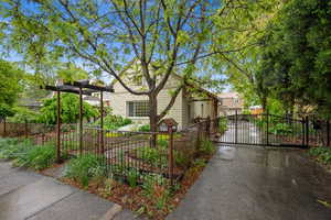 View of front of house featuring a fenced front yard, a gate, and driveway