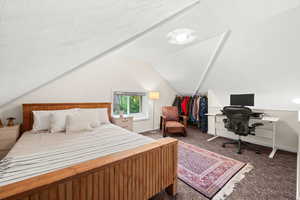 Freshly painted upstairs bedroom featuring lofted ceiling