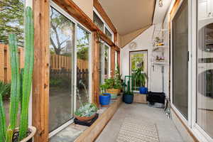 South facing sunroom featuring independent thermostat controlled radiant heat in floor, updated electric wiring, doors to the house and to the backyard
