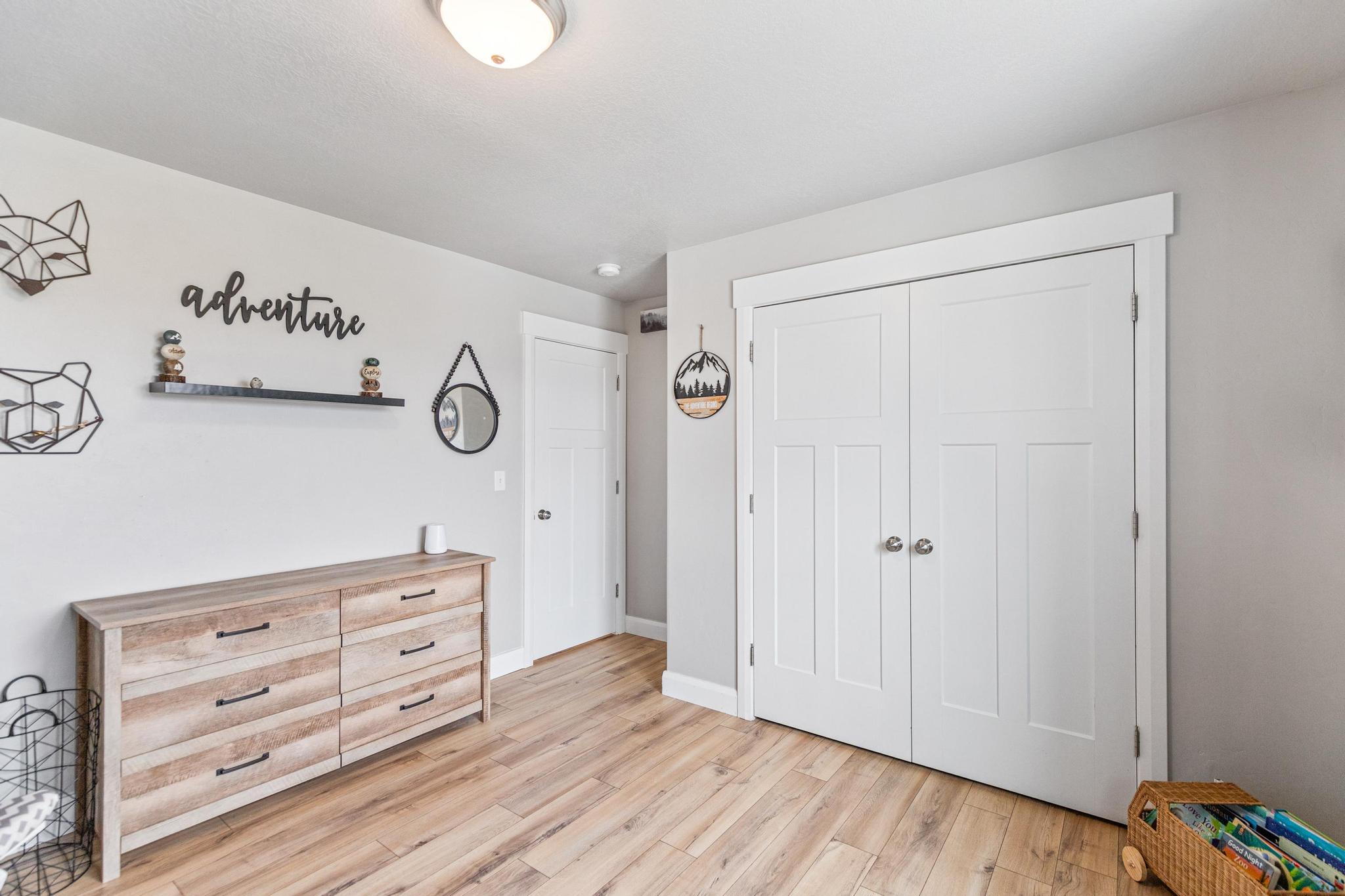 Unfurnished bedroom featuring light wood finished floors and a closet