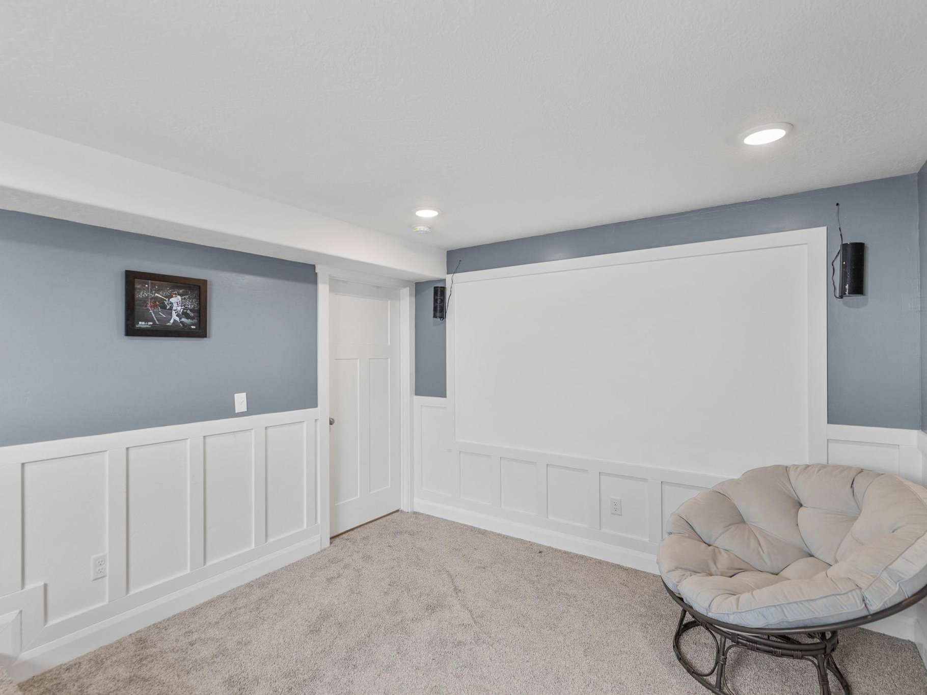 Unfurnished room with a decorative wall, wainscoting, recessed lighting, and carpet floors