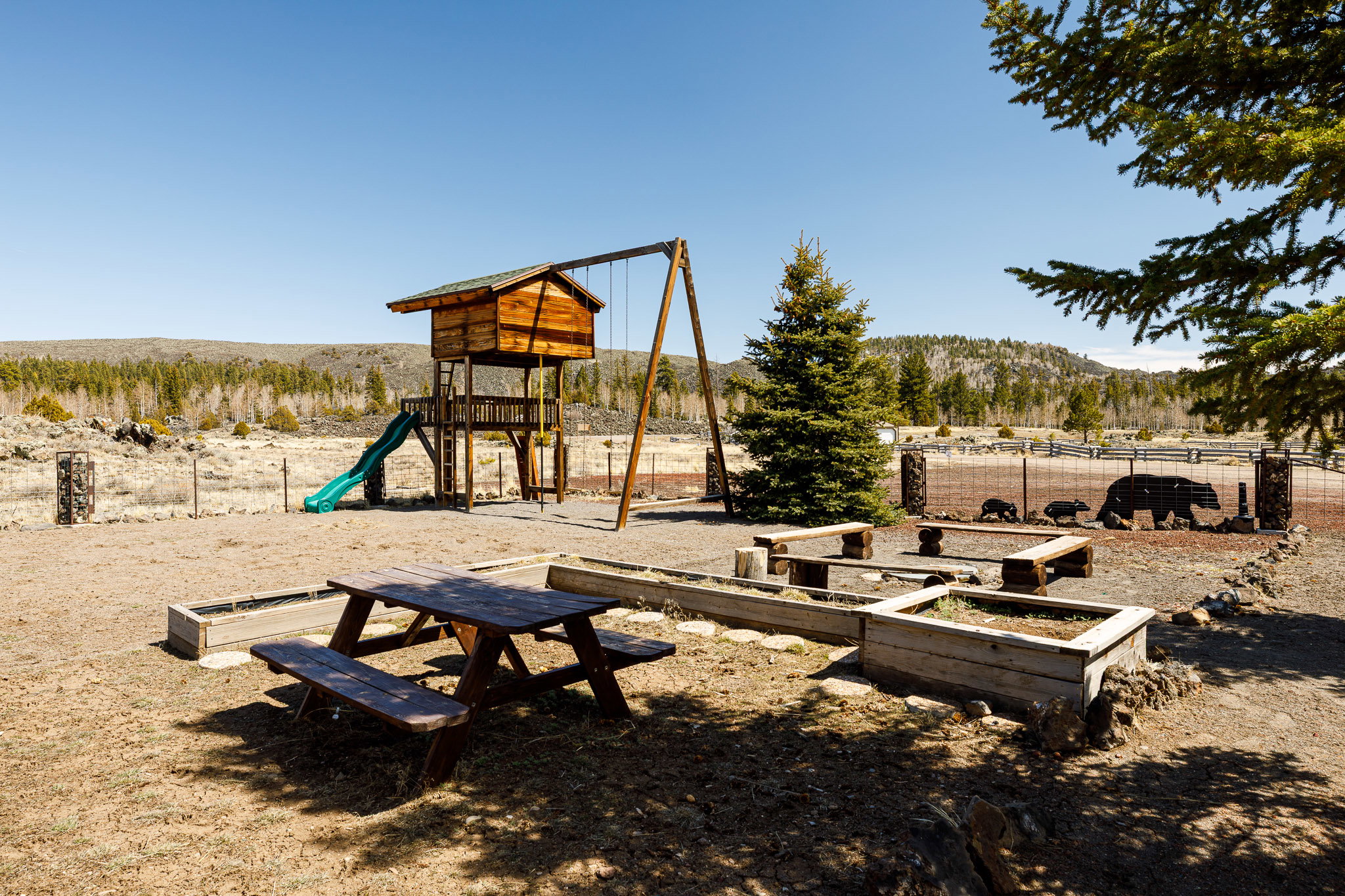 Community playground with a mountain view, a view of rural / pastoral area, and a vegetable garden