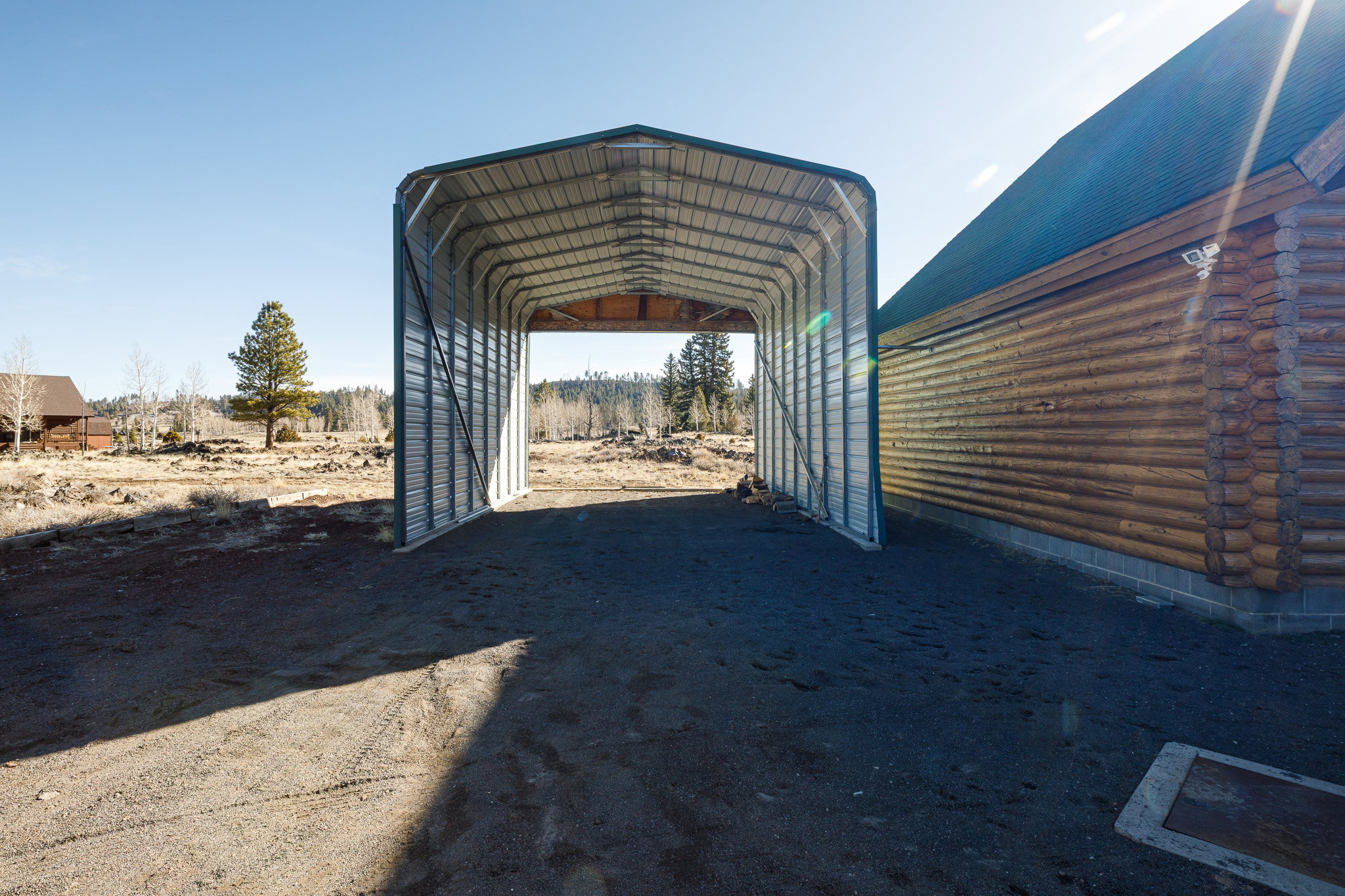 View of parking with a carport and driveway