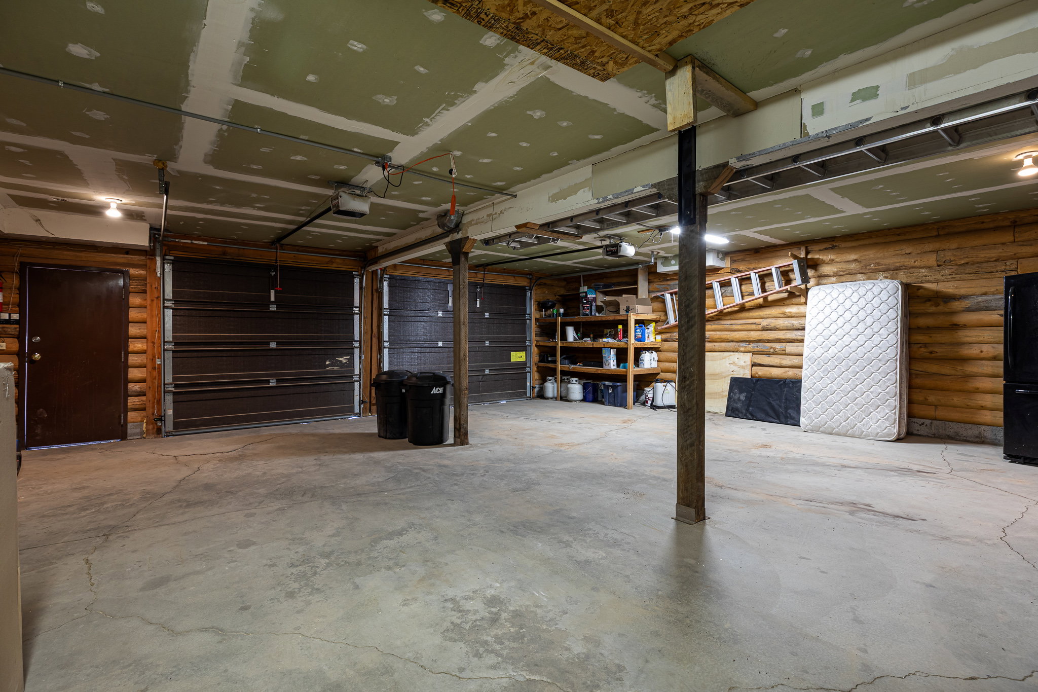 Garage with freestanding refrigerator and a garage door opener