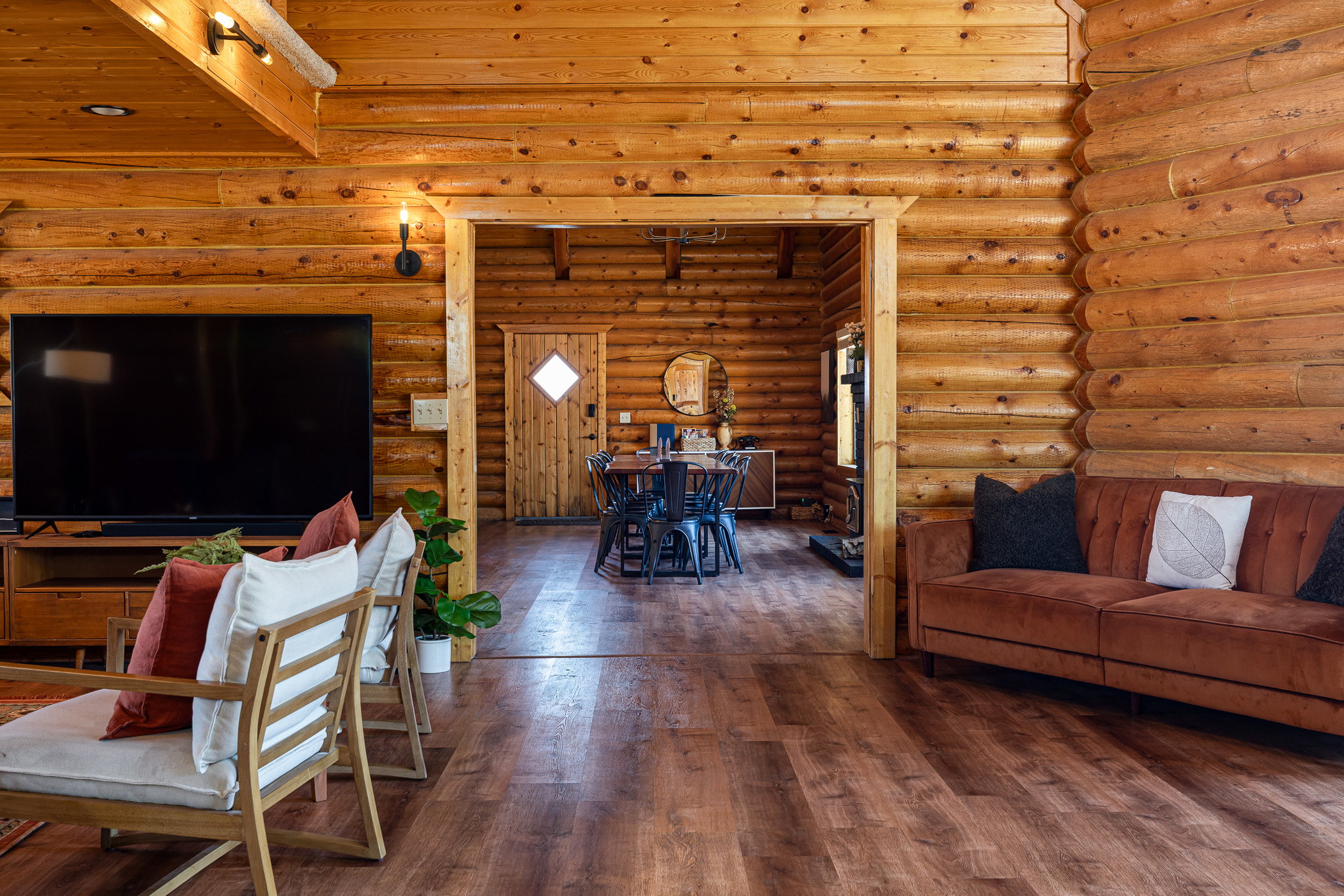 Living room featuring hardwood / wood-style floors, rustic walls, and wood ceiling