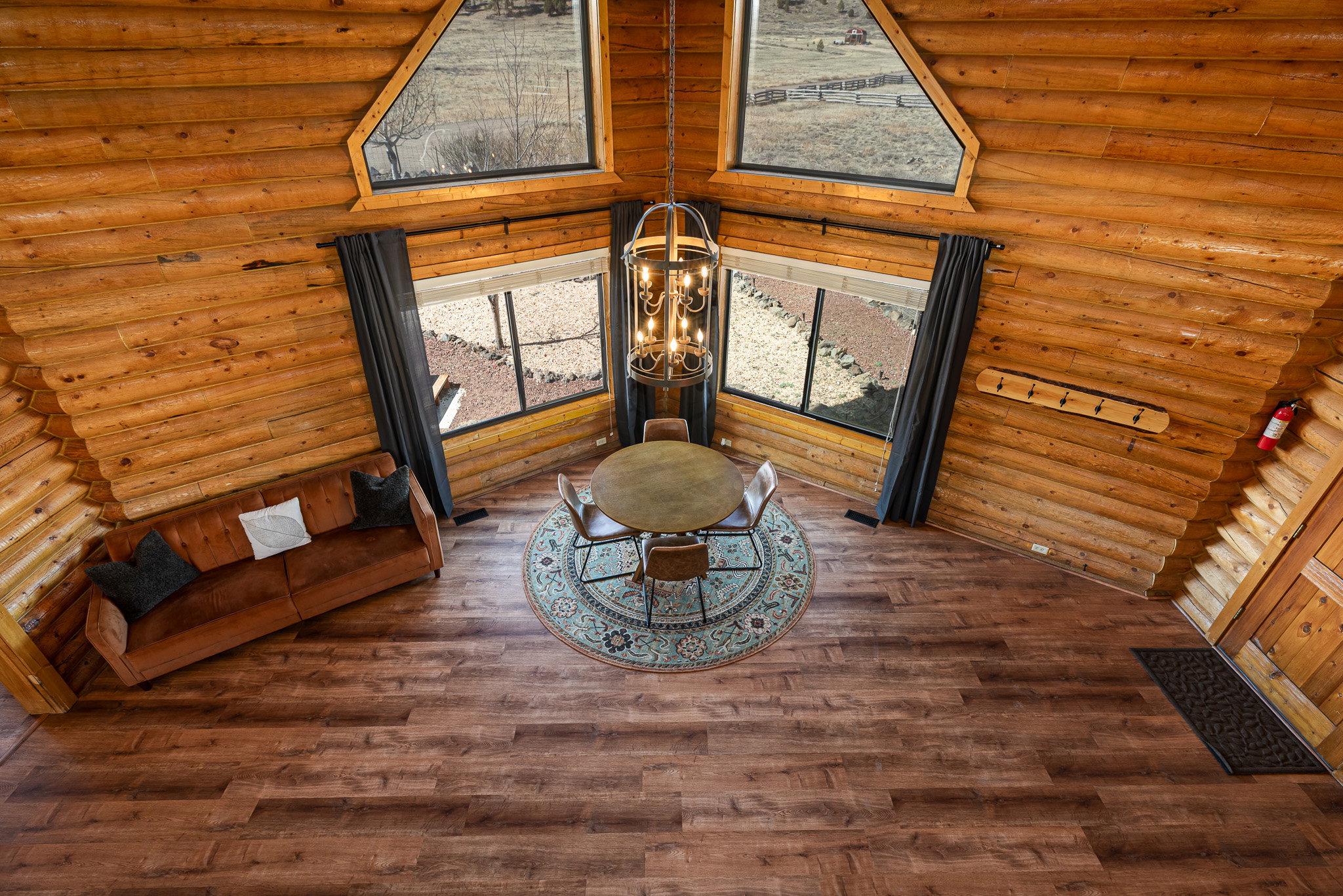 Detailed view of suspended lighting, rustic walls, and wood finished floors