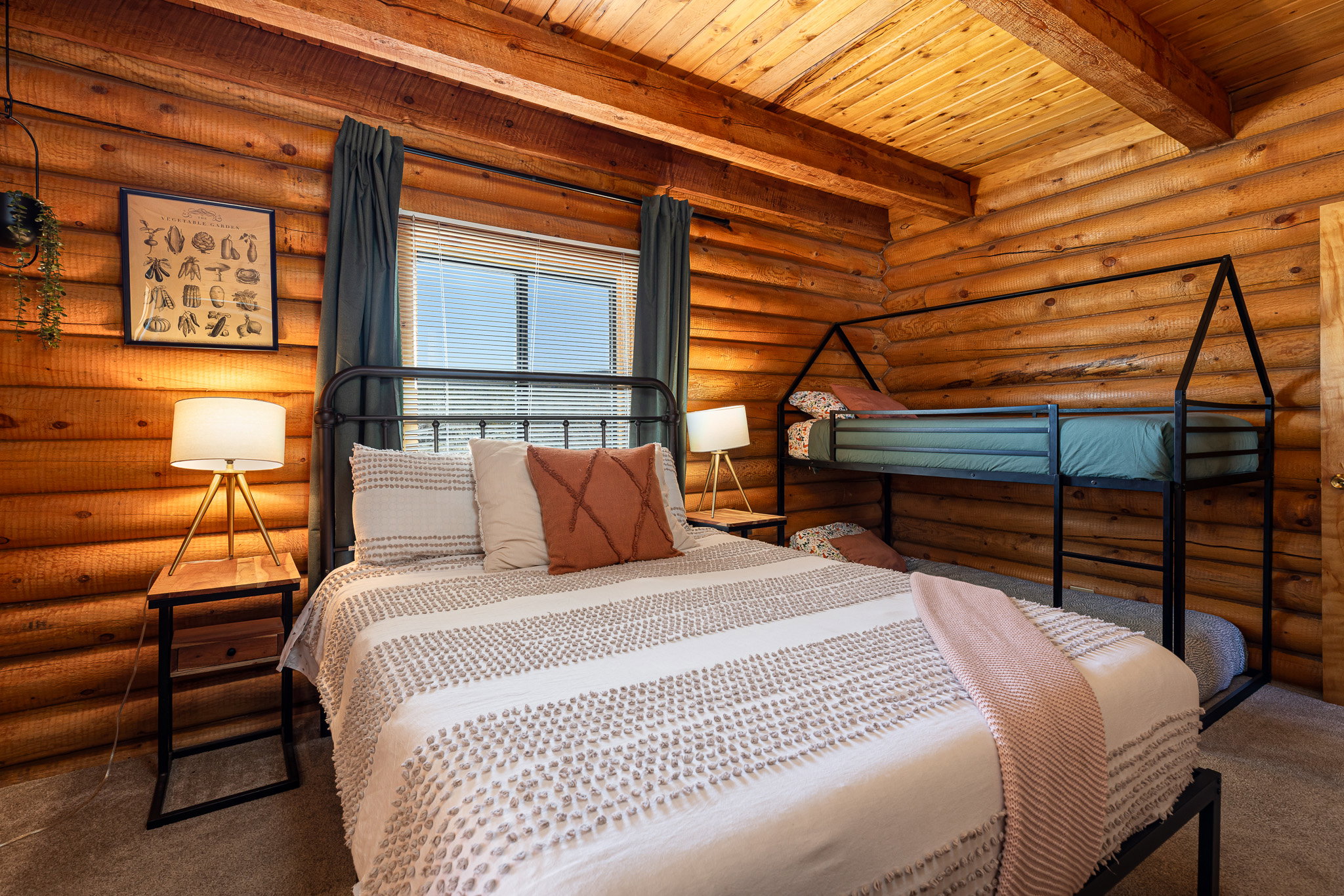 Bedroom featuring log walls, carpet floors, and a wood ceiling with exposed beams