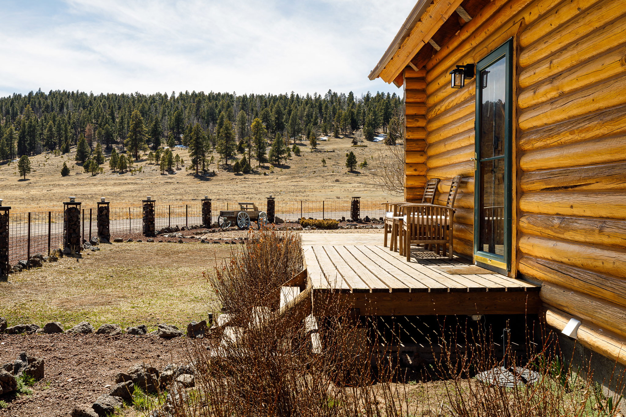 View of yard featuring a wooden deck and a view of rural / pastoral area