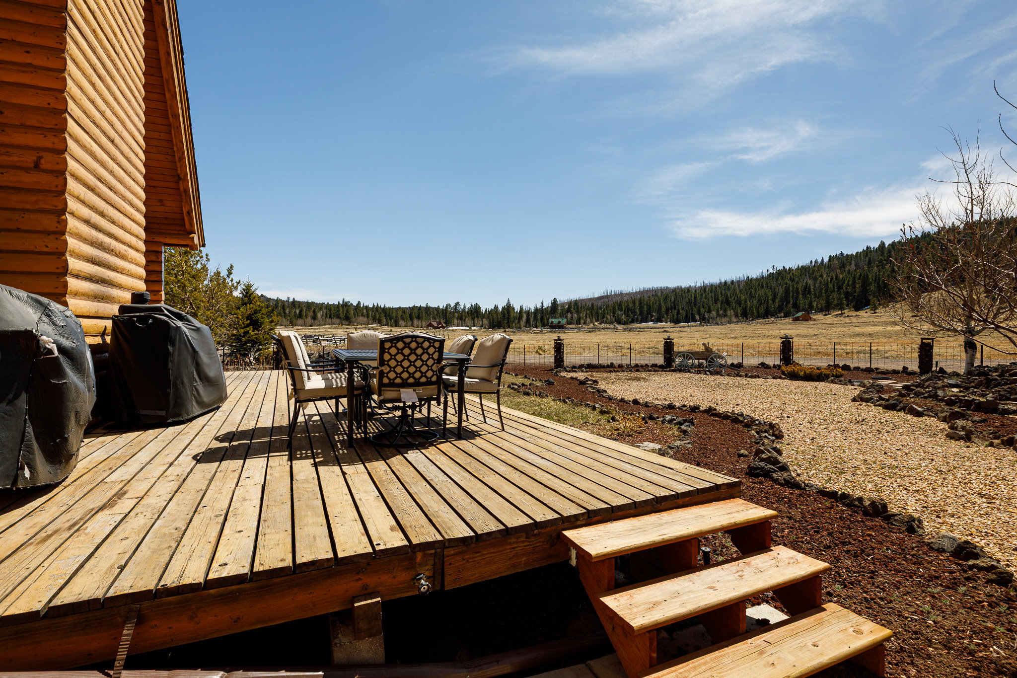 Wooden deck featuring outdoor dining area and area for grilling