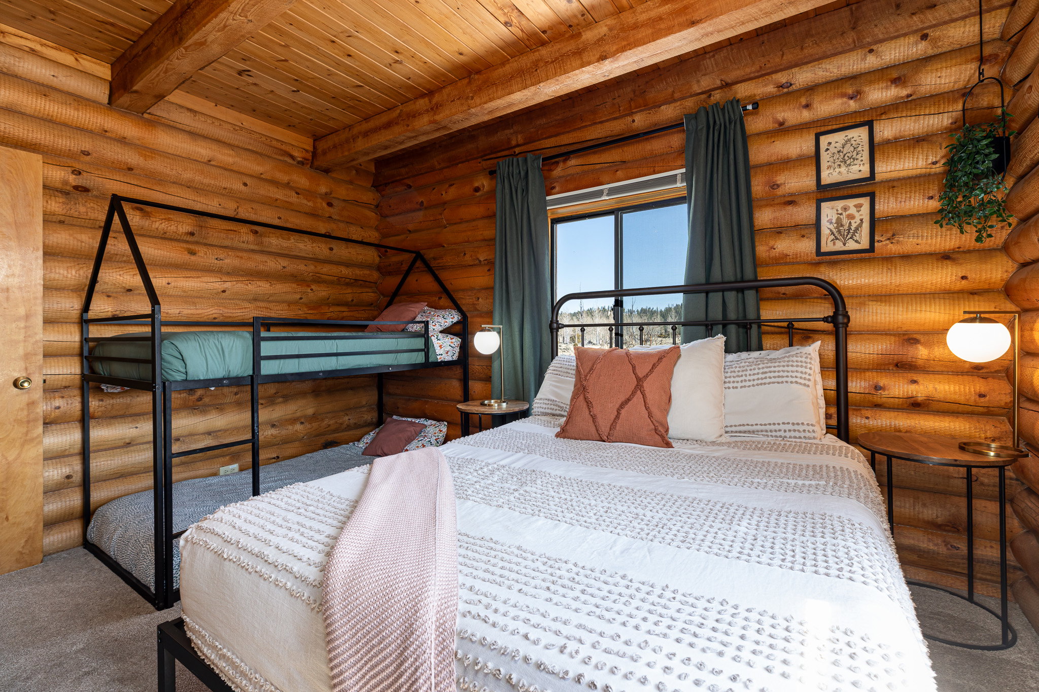 Carpeted bedroom featuring rustic walls and a wooden ceiling with exposed beams
