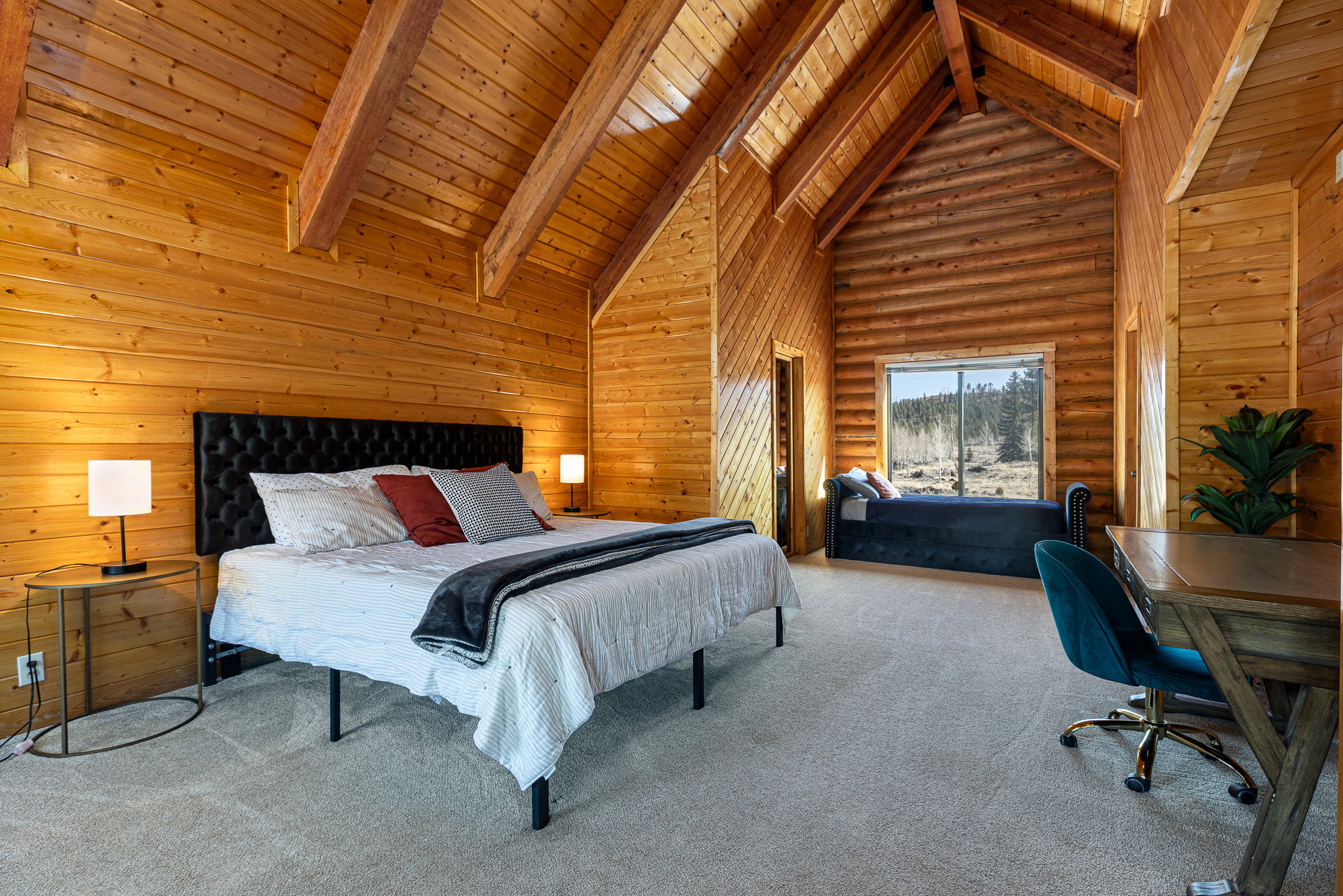 Bedroom featuring carpet floors, wood walls, a high wooden beamed ceiling, and rustic walls