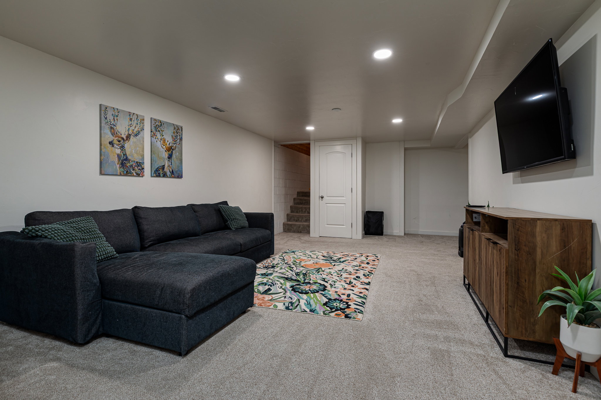 Living room with light carpet and recessed lighting