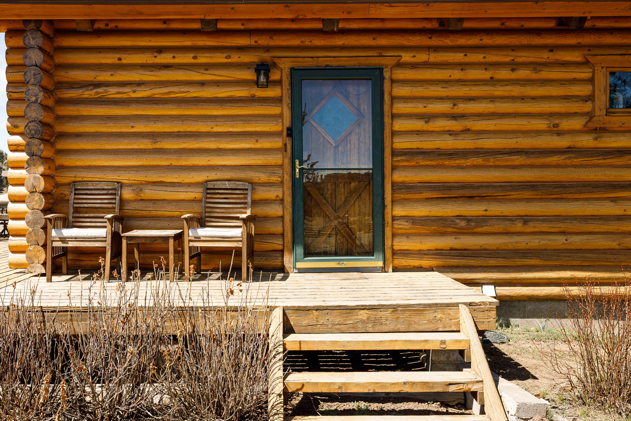 Property entrance featuring log exterior