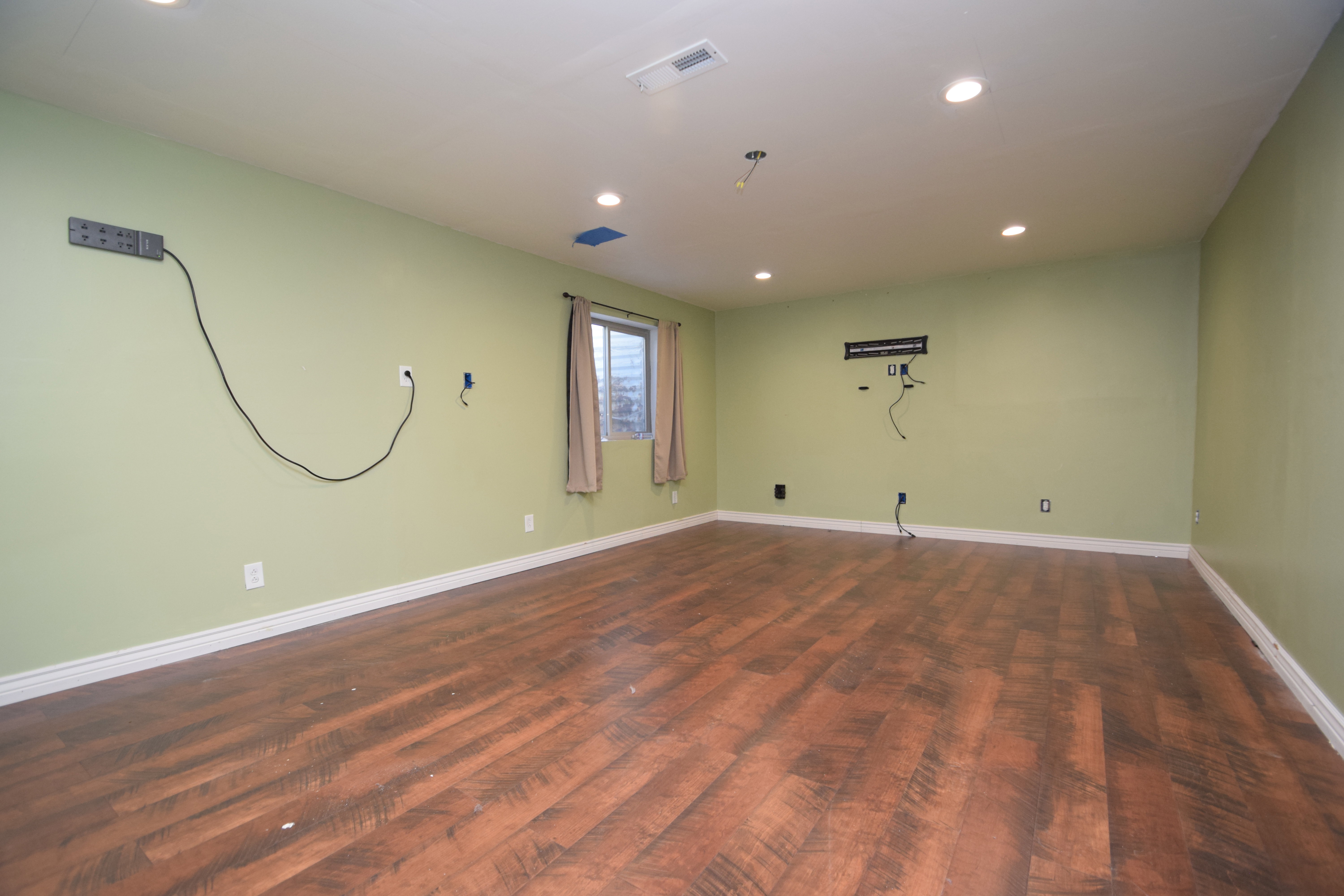 Empty room featuring recessed lighting and dark wood-style flooring