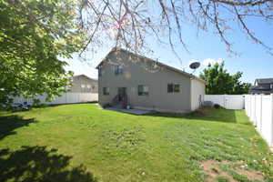 Back of property with a gate, a fenced backyard, a patio, and entry steps
