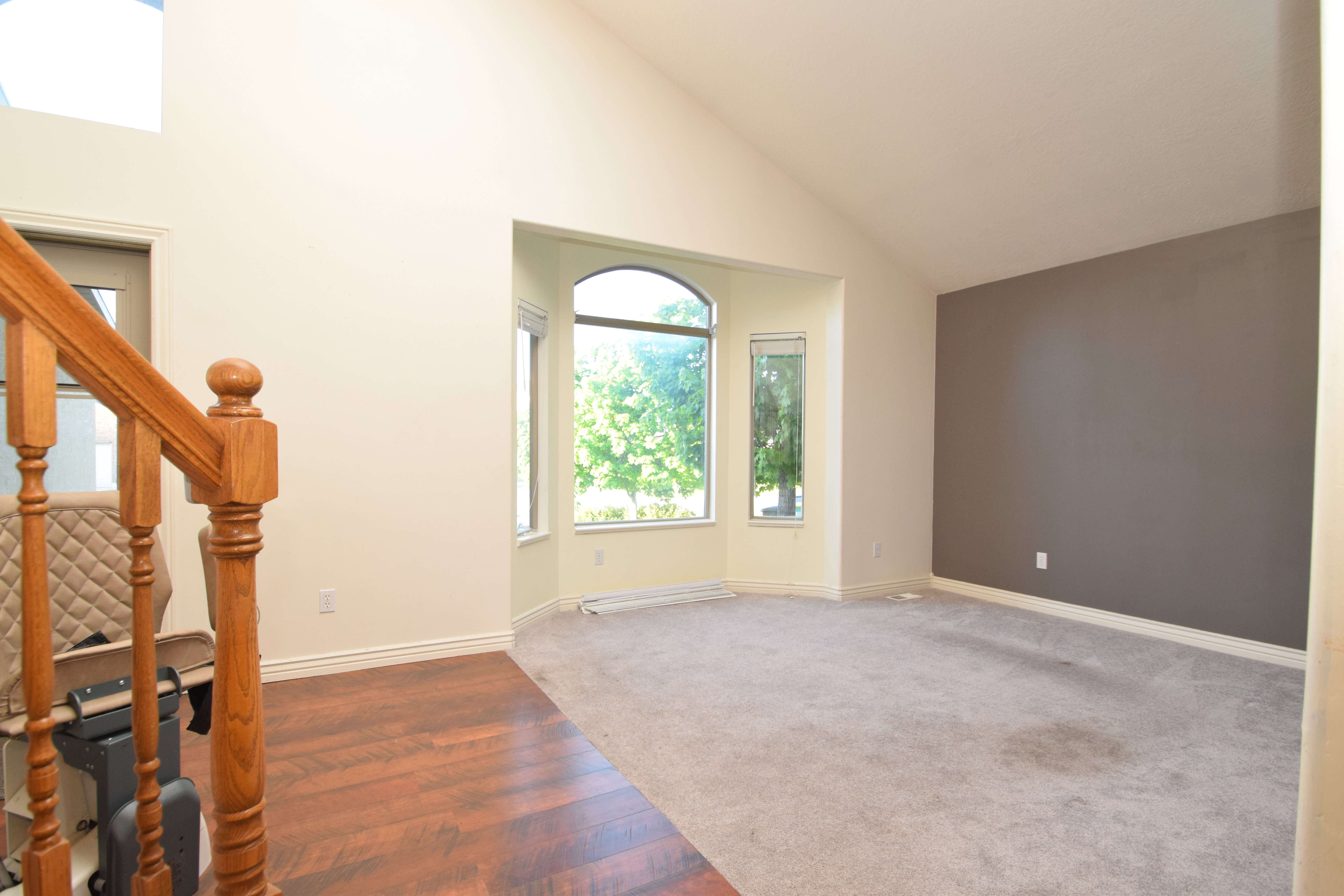 Entrance foyer with lofted ceiling and wood finished floors