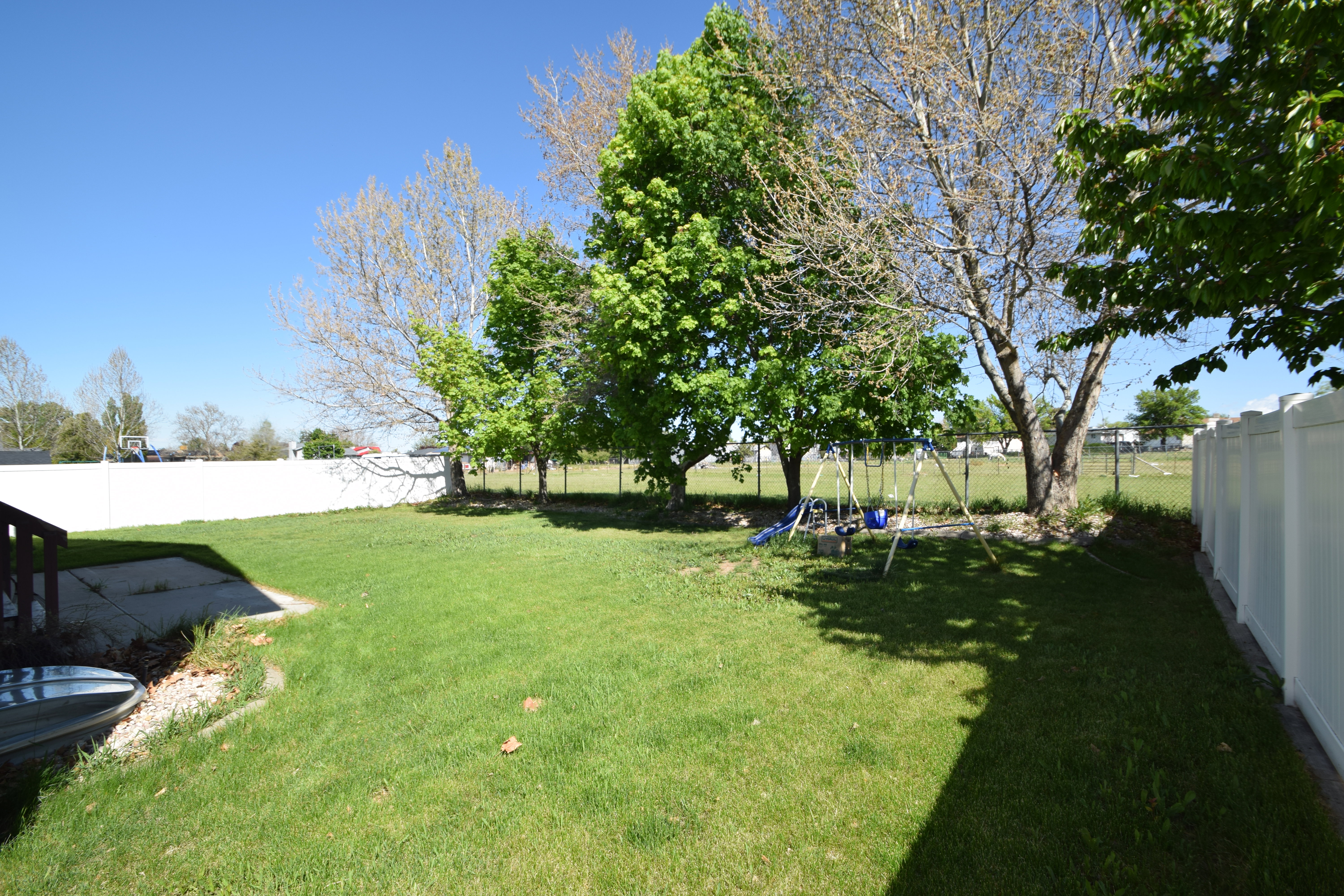Fenced backyard with a playground