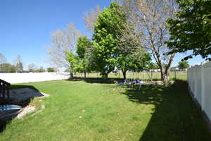 Fenced backyard with a playground